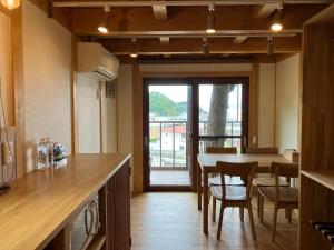 a kitchen and dining room with a table and chairs at MY LODGE Naoshima in Naoshima