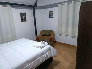 Rúm í herbergi á Hostal Ayllu