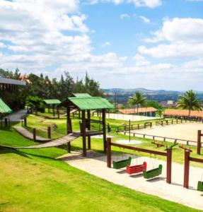 a park with a playground with benches and picnic tables at Flat Fazenda Monte Castelo in Bezerros +37 photos