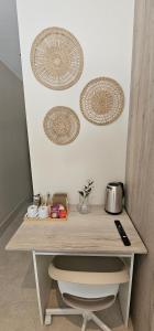 a wooden desk with three plates on the wall at MSM Arena Hotel in London