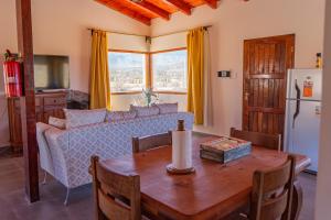 a living room with a table and a couch at Cabaña Puertas del Cielo in Cachí