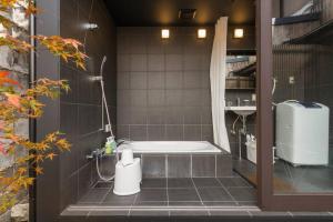 a bathroom with a shower and a bath tub at 吉祥庵 in Nishinotōindōri +74 photos