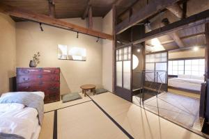 a large room with a bed and a bedroom with a bunk bed at 吉祥庵 in Nishinotōindōri