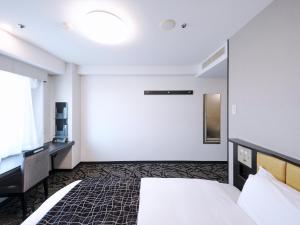 Postel nebo postele na pokoji v ubytování APA Hotel Tottori Ekimae Minami