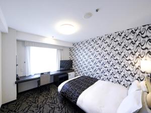Postel nebo postele na pokoji v ubytování APA Hotel Tottori Ekimae Minami