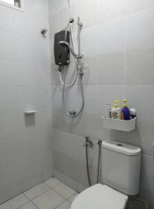 a bathroom with a shower and a toilet in it at 4-Bedroom Homestay in Taiping, Perak in Kamunting +10 photos