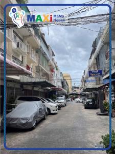 a street with cars parked next to some buildings at MAXi MaMa House in Bangkok