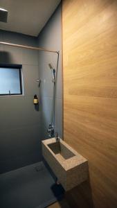 a bathroom with a sink and a shower at Vivids Hotel in Kuala Lumpur