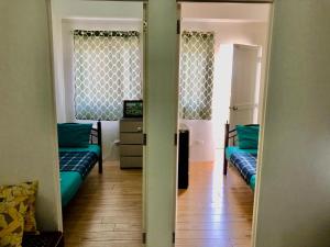 a hallway with two couches in a room with a television at Riverside 2 Bedroom 5 Beds in Naga +25 photos