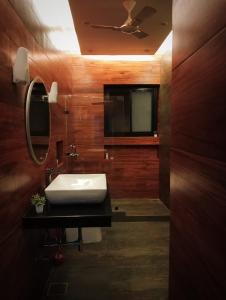 a bathroom with a sink and a mirror at Nawabi SunRise HomeStay in Lucknow