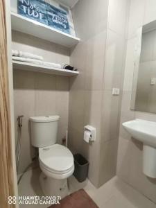 a bathroom with a white toilet and a sink at Inspiria Condo Davao - Olivia's Haven in Davao City
