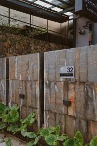 a wooden fence with the number on it at Susu Homestay Hue in Thôn Kim Long (1)