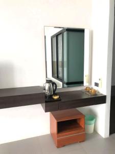 a bathroom with a counter with a mirror on it at Rockstar Beach Apartments in Bang Rak Beach +50 photos