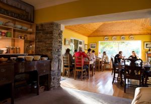 a group of people sitting at a table in a restaurant at Sharamore House B&B in Clifden