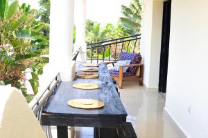 a table on a balcony with pizzas on it at Impano Guest House in Kigali