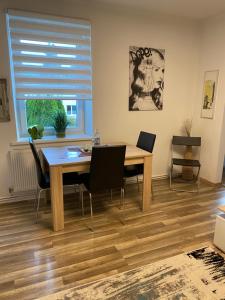 a dining room with a wooden table and chairs at DC Room Birgit in Zeltweg