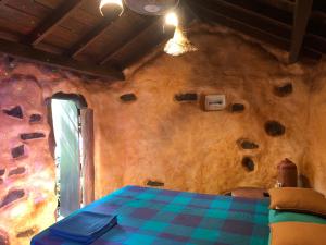 a room with a table and a wall with rocks at Villa rock by earth house in Matugama