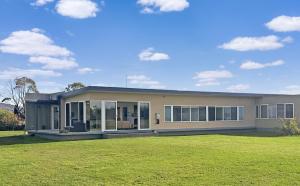 a large house with a large lawn in front of it at Lawsons Retreat in St Helens