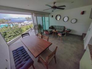 un salon avec une table et un canapé dans l'établissement Beachfront Bliss at Aria Ocean Flamingos, à Nuevo Vallarta