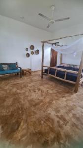 a dirty room with two beds and a dirty floor at Maisha ni sasa Bungalows in Nungwi