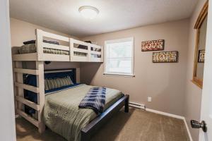 a bedroom with a bunk bed and a window at Indoor Hot-Tub! Spacious & Updated MQT Township Home! in Marquette +27 photos