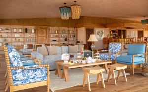 a living room with blue chairs and a table at One Nature Mara River in Serengeti National Park