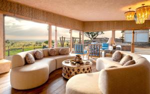 a large living room with couches and a table at One Nature Mara River in Serengeti National Park