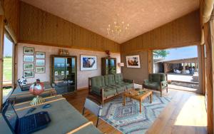 a living room with a couch and a table at One Nature Mara River in Serengeti National Park