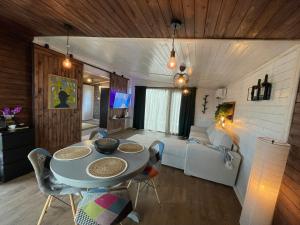 a living room with a table and a couch at Chalet 317 in Ucea de Sus