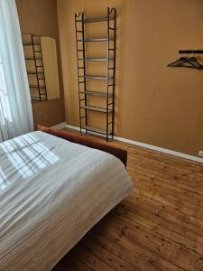 a bedroom with a bed and a wooden floor at Authentique maison Morlaisienne in Morlaix +22 photos