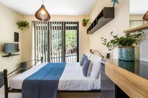 a bedroom with a bed and a window at Arapaki Secret Garden, Ground Floor 2-bed Deluxe Suite, Private Pool & Sea View in Vournikás