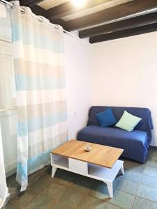 a blue couch in a room with a coffee table at Ο Παράδεισος της Αφροδίτης in Kalymnos
