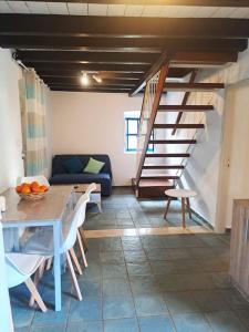 a living room with a table and a staircase at Ο Παράδεισος της Αφροδίτης in Kalymnos +42 photos