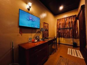 a living room with a flat screen tv on the wall at Ombak Dive Resort Perhentian Island in Perhentian Islands