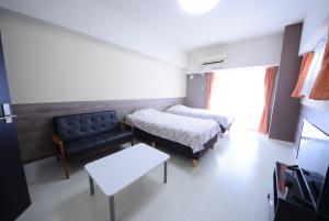 a hospital room with two beds and a couch at Sumuka Asato Station 1K[F-5] in Naha
