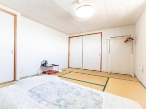Postel nebo postele na pokoji v ubytování Tabist Hara Business Ryokan