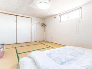 Postel nebo postele na pokoji v ubytování Tabist Hara Business Ryokan