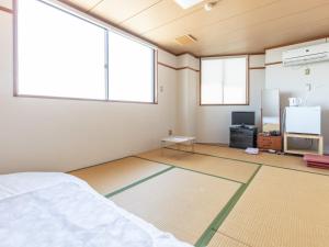 Postel nebo postele na pokoji v ubytování Tabist Hara Business Ryokan