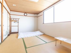 Postel nebo postele na pokoji v ubytování Tabist Hara Business Ryokan