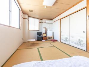 Postel nebo postele na pokoji v ubytování Tabist Hara Business Ryokan