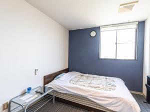 Postel nebo postele na pokoji v ubytování Tabist Hara Business Ryokan