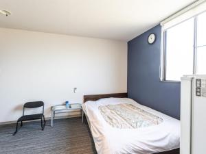Postel nebo postele na pokoji v ubytování Tabist Hara Business Ryokan