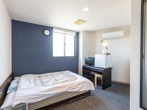 Postel nebo postele na pokoji v ubytování Tabist Hara Business Ryokan