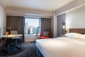 a hotel room with a large bed and a window at Courtyard by Marriott Shin-Osaka Station in Osaka