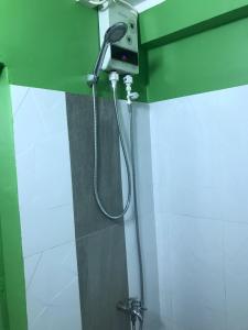 a shower in a bathroom with a shower head at Route 76 Guest House in Sen Monorom
