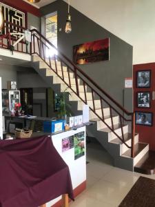 a staircase in a living room with a purple blanket at Route 76 Guest House in Sen Monorom