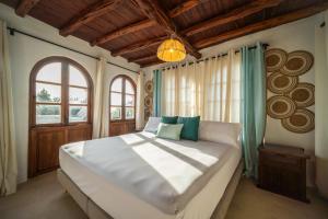 a bedroom with a large bed and a window at Can Pla Roig con vistas al Mar y la Puesta de Sol in Sant Joan de Labritja +35 photos