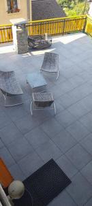 two chairs and a table on a patio at Appartements en Montagnes in Aime-La Plagne