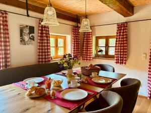 a dining room table with plates of food on it at Chalet Dürrfeld ***** in Viechtach