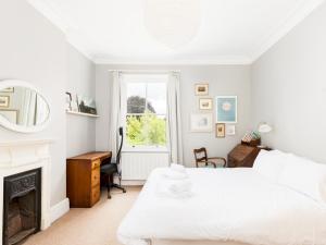 a bedroom with two beds and a fireplace at Spacious Family 3Bed on Leam Terrace with Parking Pass the Keys in Leamington Spa +5 photos